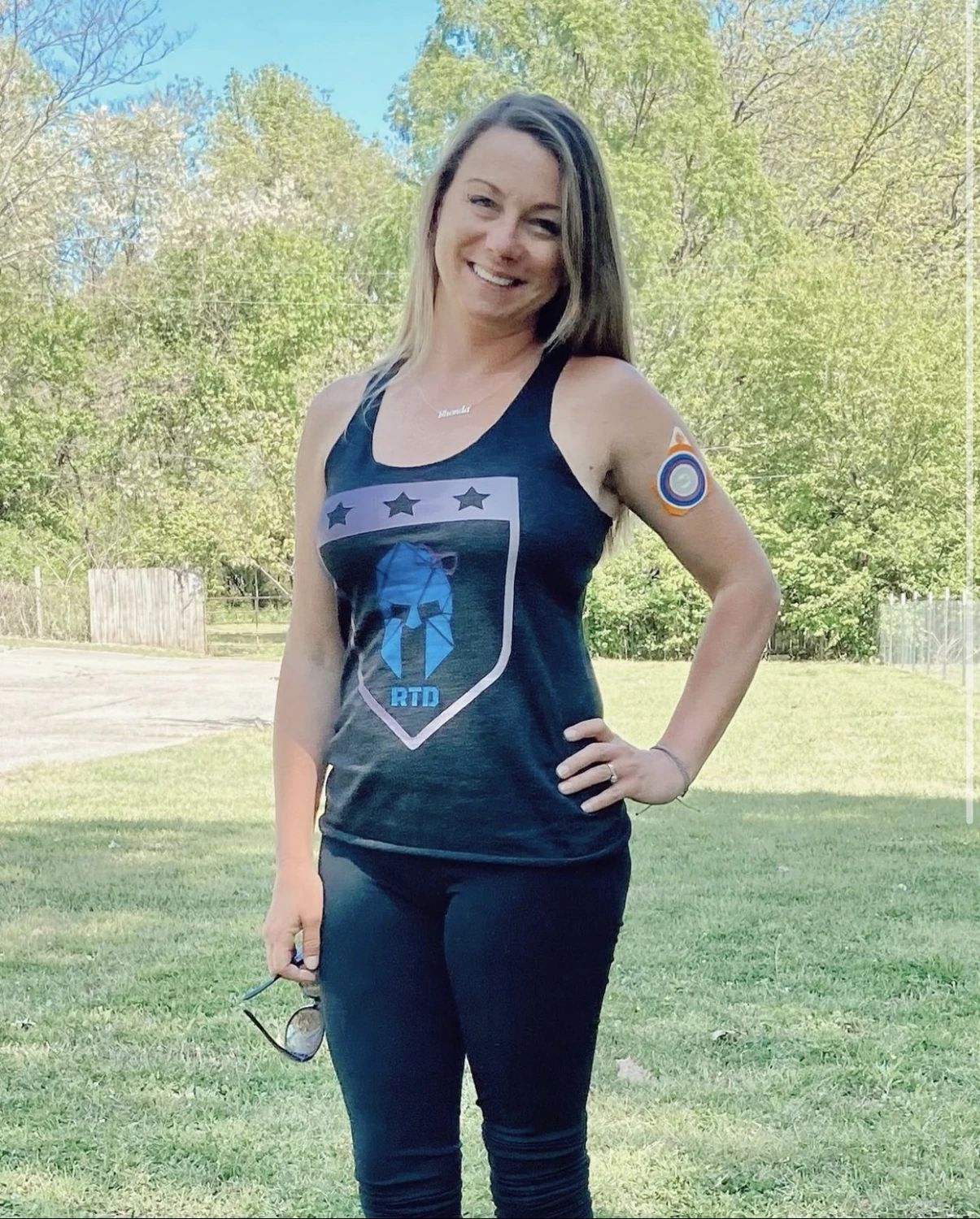 RTD ambassador wearing a black Raising Tactical Daughters tank outdoors